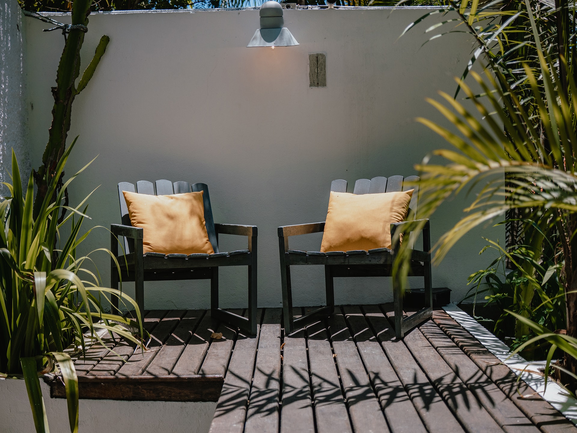 Two,Armchairs,With,Yellow,Cushions,On,Wooden,Deck,,Modern,Outdoor