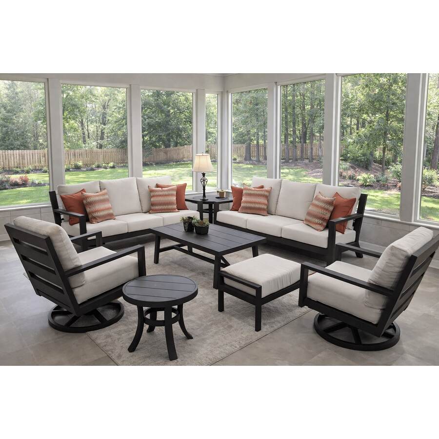 Dark frame outdoor sectional with light cushions on a screened porch