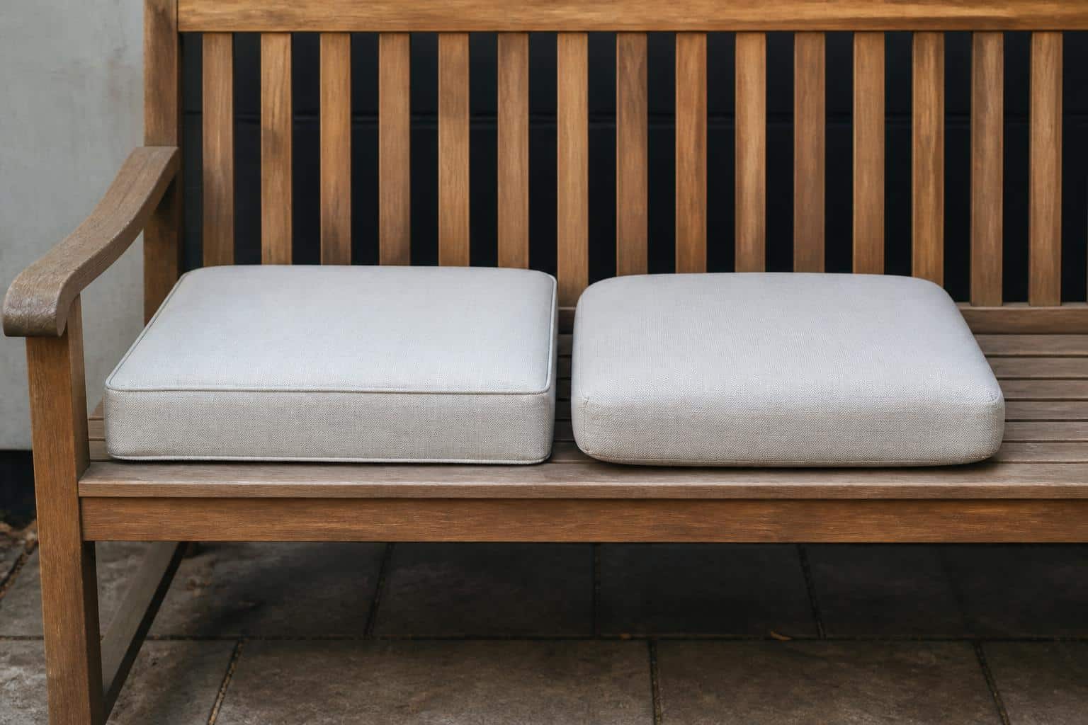 Side-by-side comparison of a boxed outdoor cushion with squared edges and a waterfall cushion with a rounded front on a patio chair