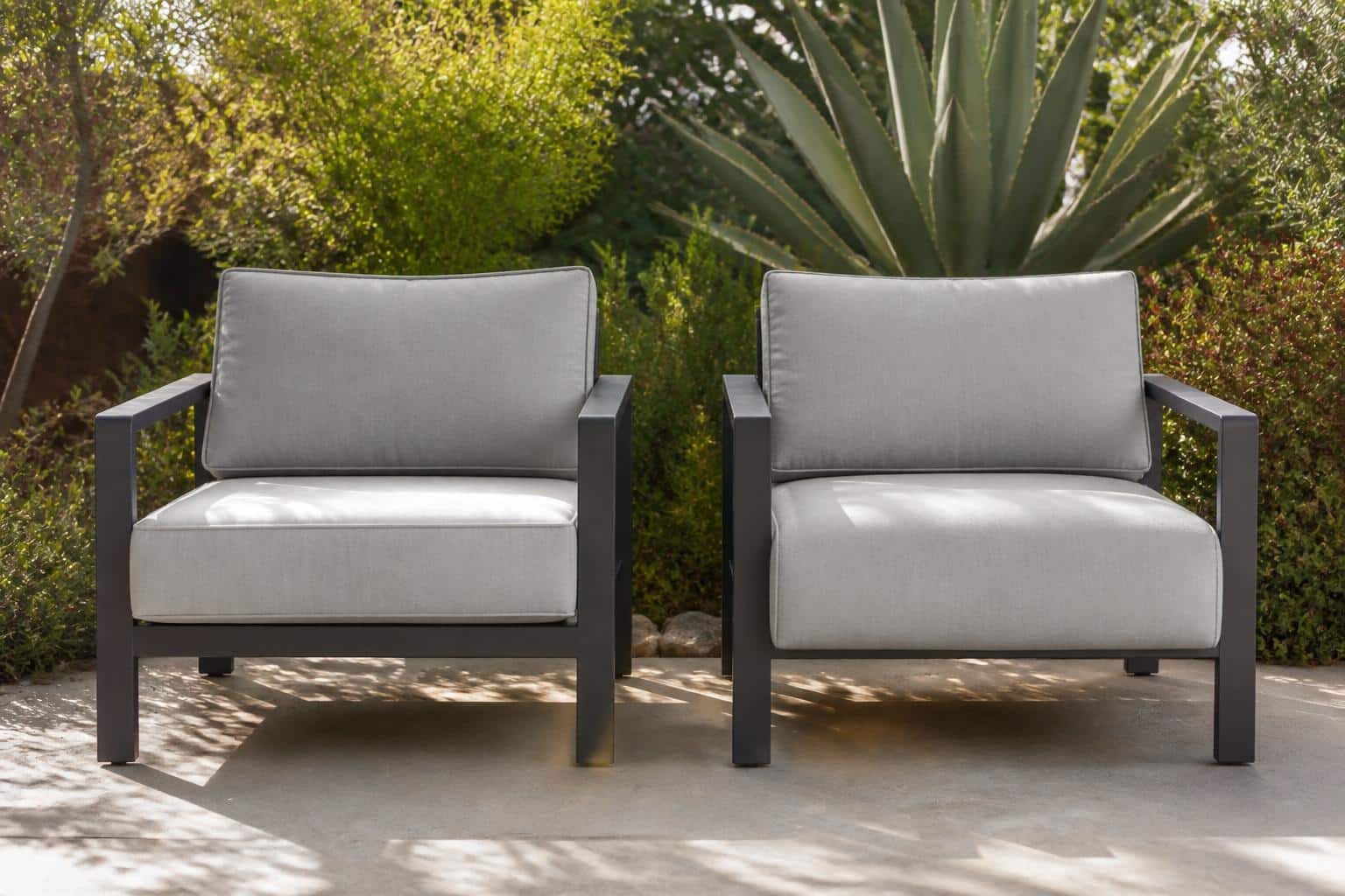 Wide view of a patio seating group showing how boxed and waterfall cushion shapes affect the overall look of outdoor furniture