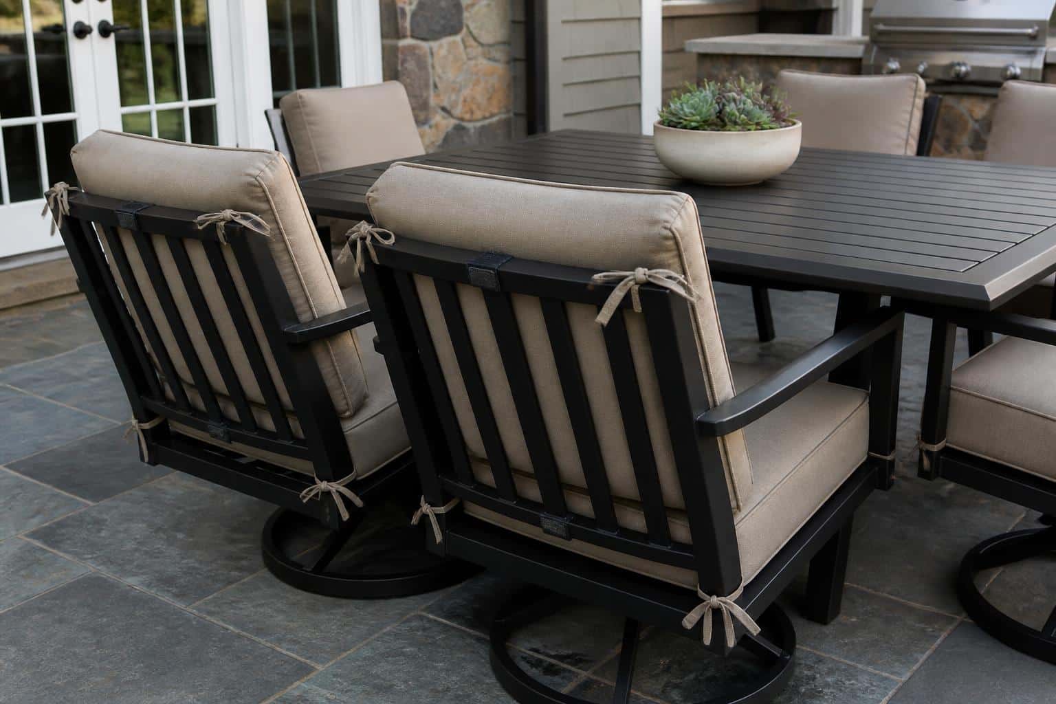 Cushioned outdoor lounge chairs arranged on a patio