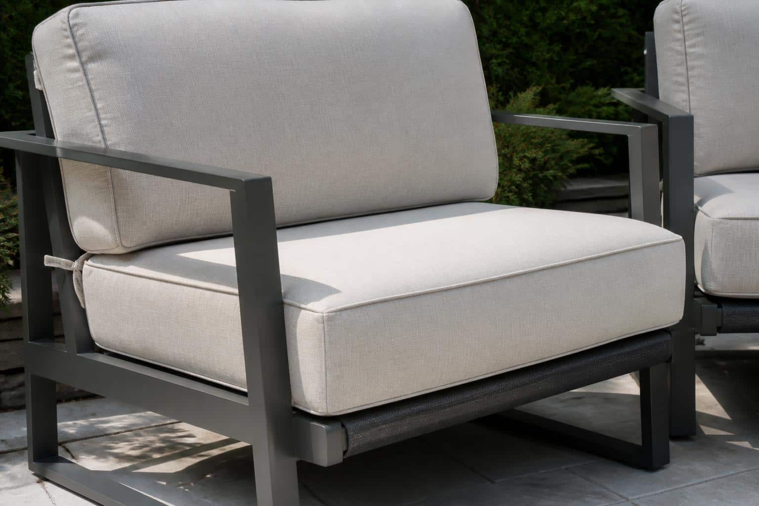 Wide view of a Charlotte patio with cushioned seating arranged with proper spacing and secured cushions