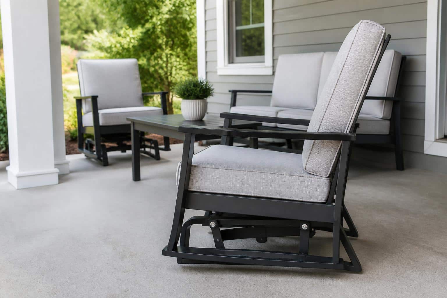 Outdoor glider chair with visible base mechanism