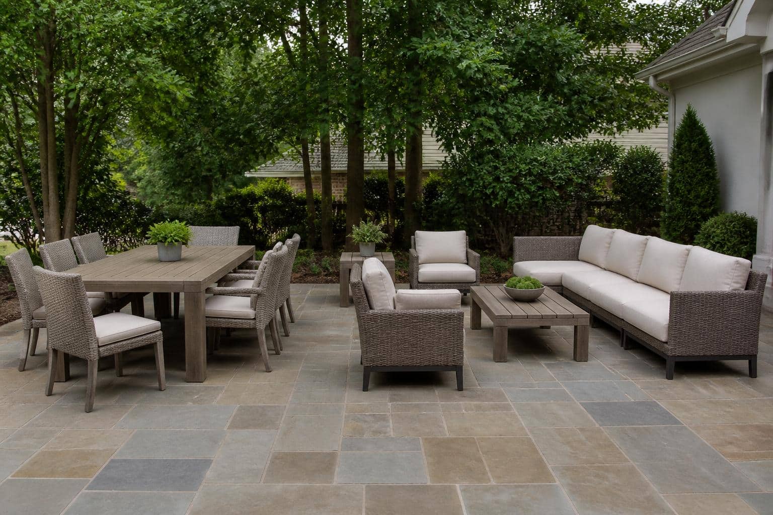 Full resin wicker seating arrangement on a Charlotte patio with coordinated table and ottoman heights