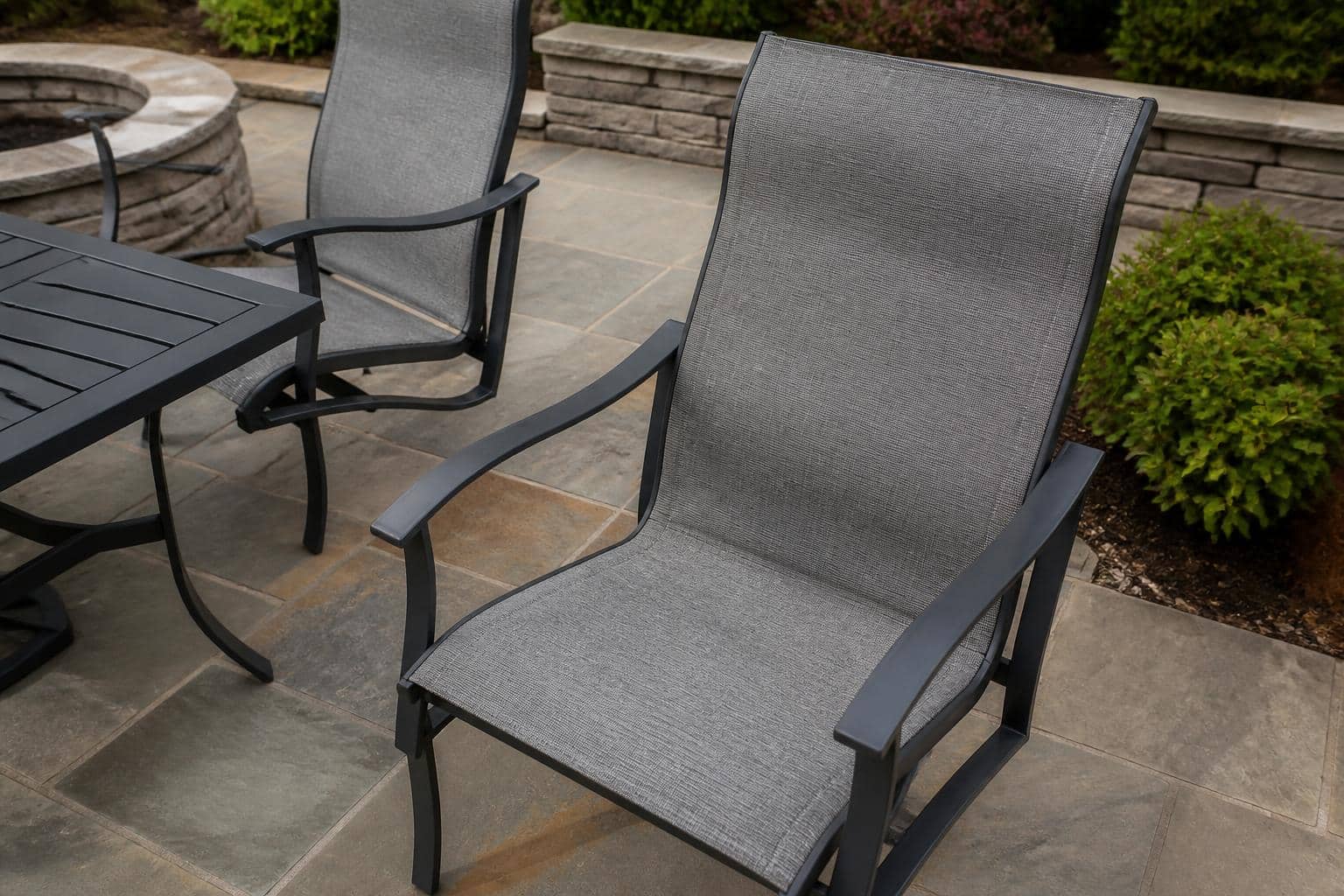 Sling patio dining chairs arranged around a table on a residential patio