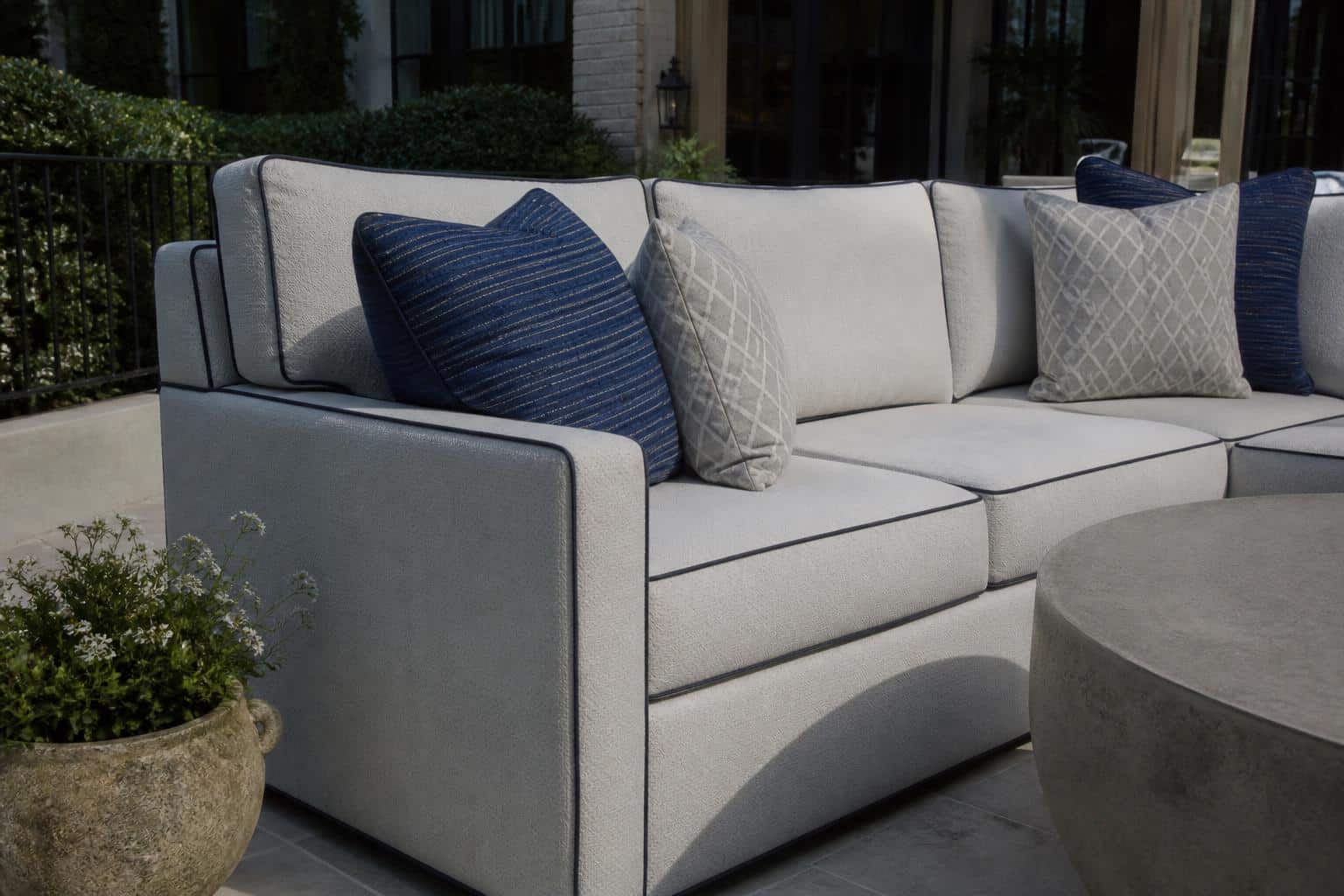 Outdoor cushions with contrasting piping and welt details