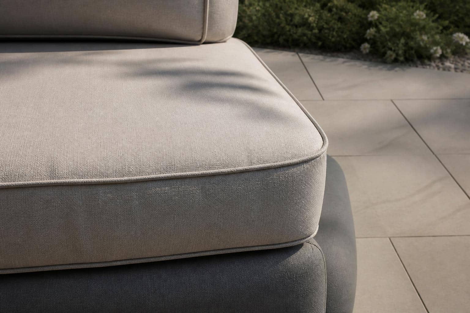 Close view of contrasting welt along a Sunbrella cushion seam on a teak lounge chair