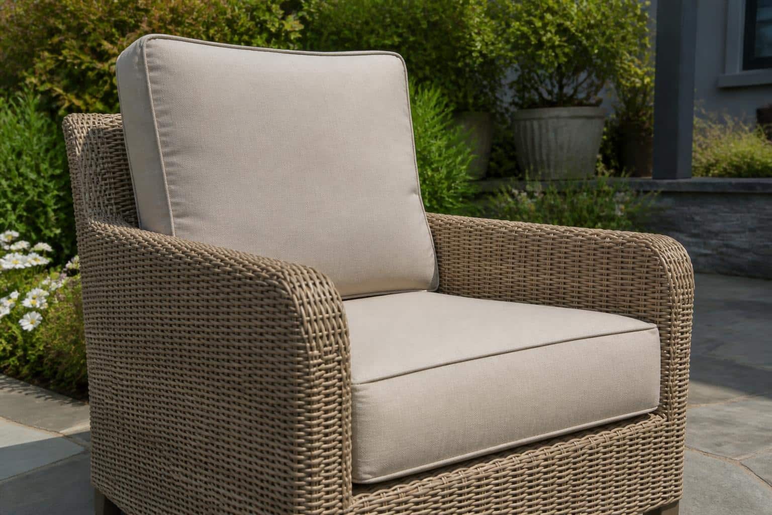 Wide view of a coordinated Charlotte patio seating arrangement with layered Sunbrella cushions and pillows